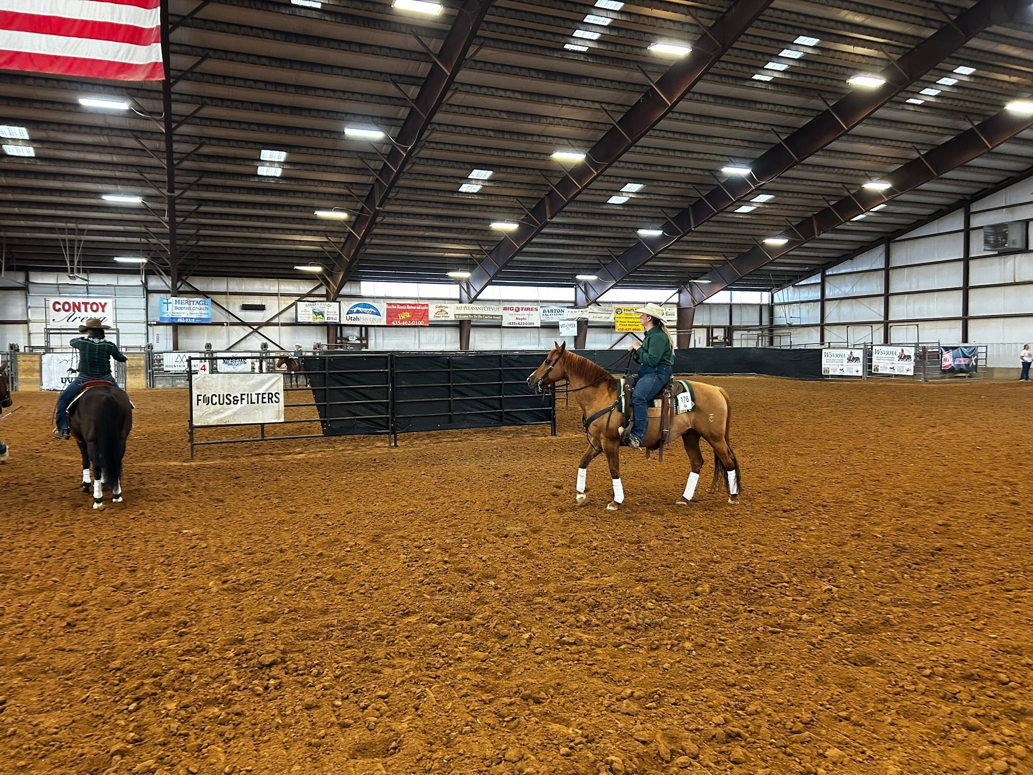 Indoor arena activity at the Cleone Peterson Eccles Equestrian Center.