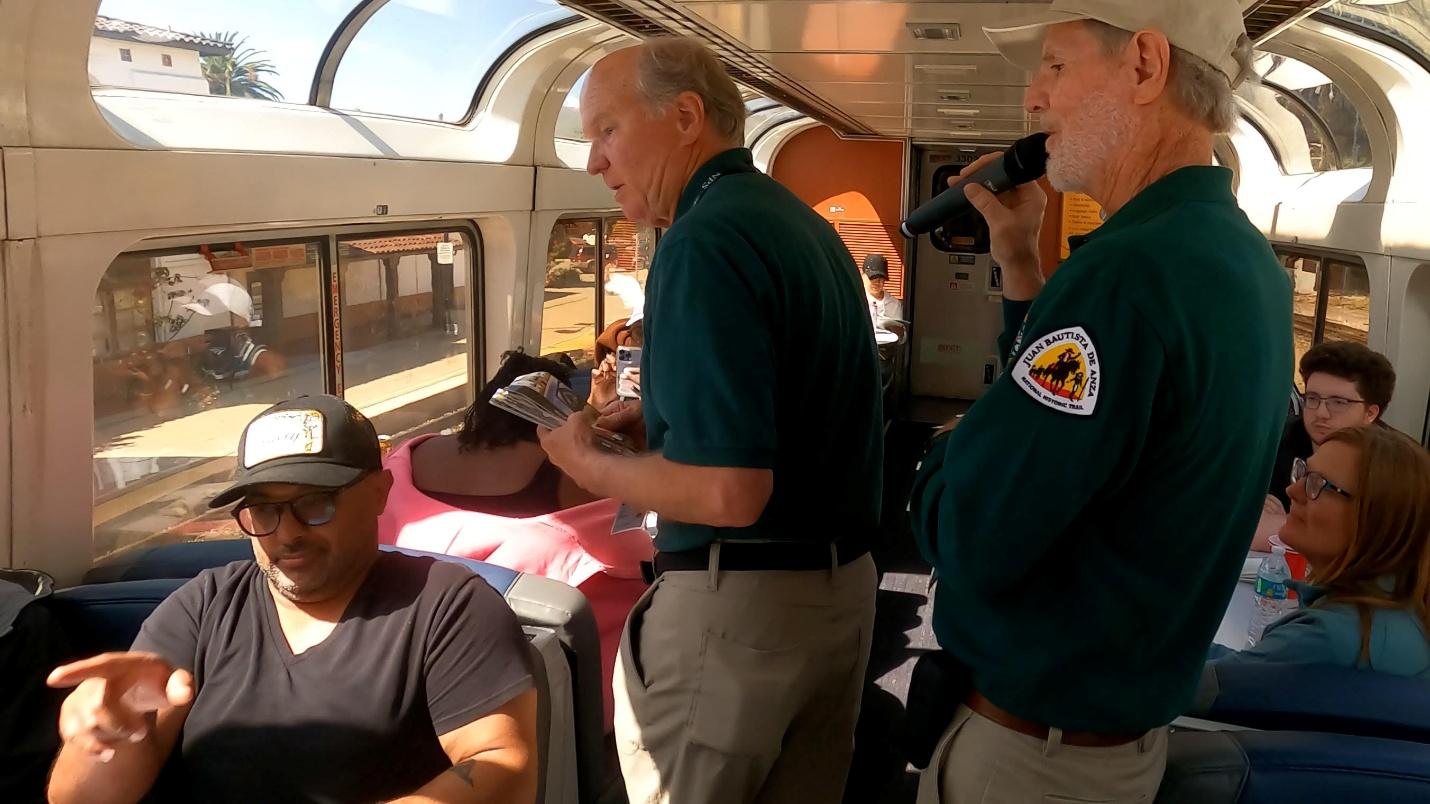 National Park Service volunteers telling the Anza story to riders on the Coast Starlight